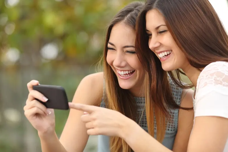 Teen girls looking at smartphone. 