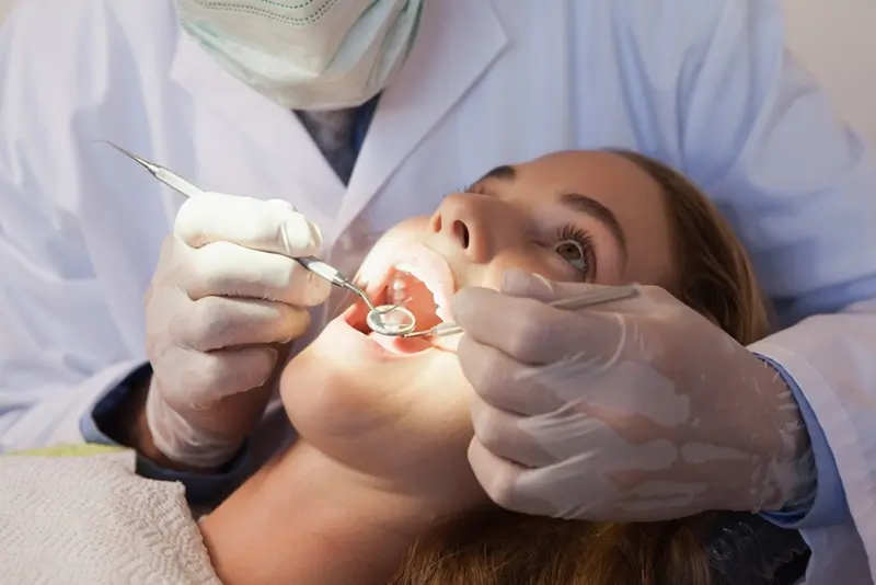 Dentist examining patient's teeth