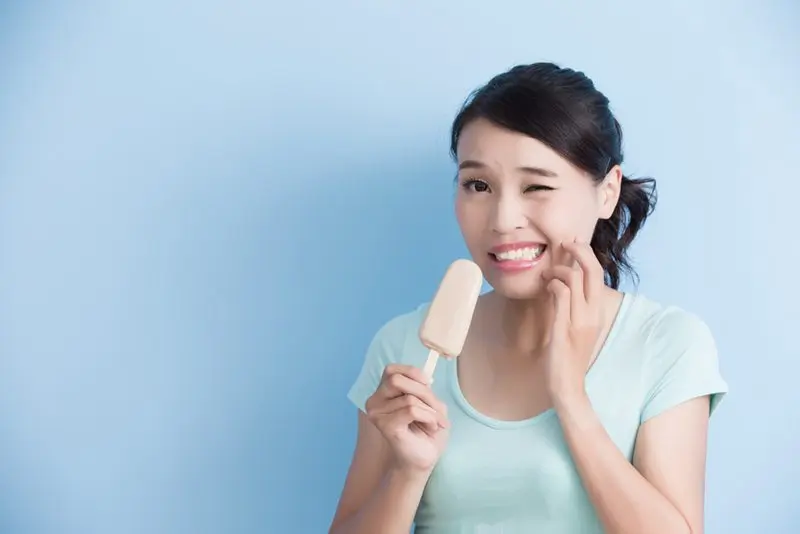 Woman eating popsicle. 