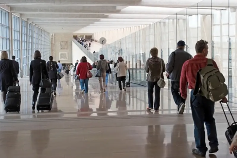 Travellers at an airport having successfully gotten through security with dental implants.