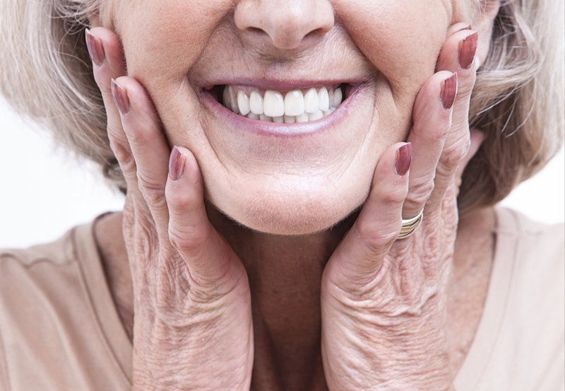 Well installed dentures, using modern techniques should be near indistinguishable from real teeth. 