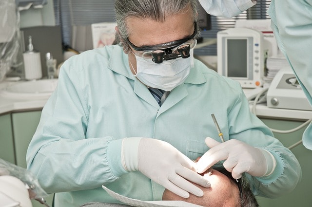 A dentist visually examining a tooth