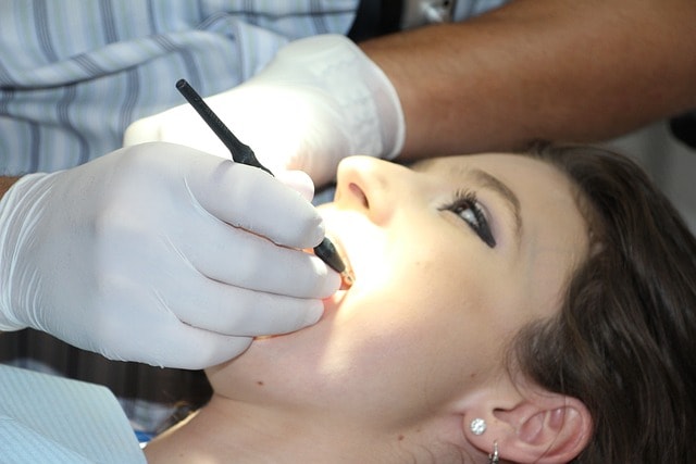 A dental professional preparing for a wisdom teeth removal procedure.